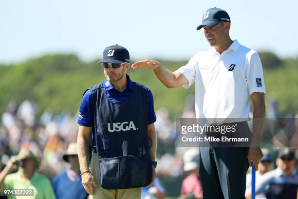 Matt Kuchar of the United States talks with caddie John Wood on the sixth hole during the first round of the 2018 U.S. Open at Shinnecock Hills Golf...