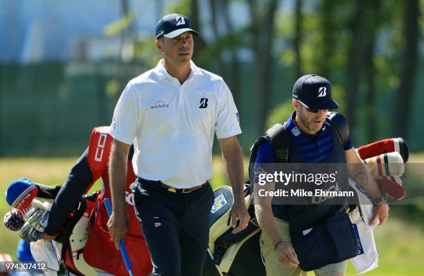 Matt Kuchar of the United States walks with caddie John Wood on the sixth hole during the first round of the 2018 U.S. Open at Shinnecock Hills Golf...