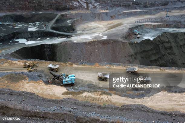 Trucks are loaded with rocks at the world's richest by production value open pit Diamond mine, Jwaneng, 160km south west of Gaborone on March 17,...