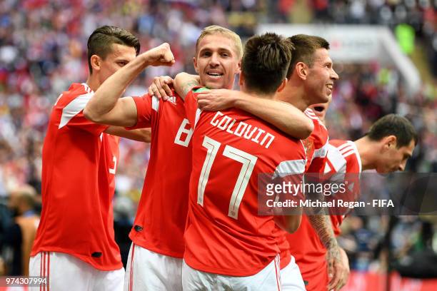 Iury Gazinsky of Russia celebrates with teammates after scoring the opening goal during the 2018 FIFA World Cup Russia Group A match between Russia...