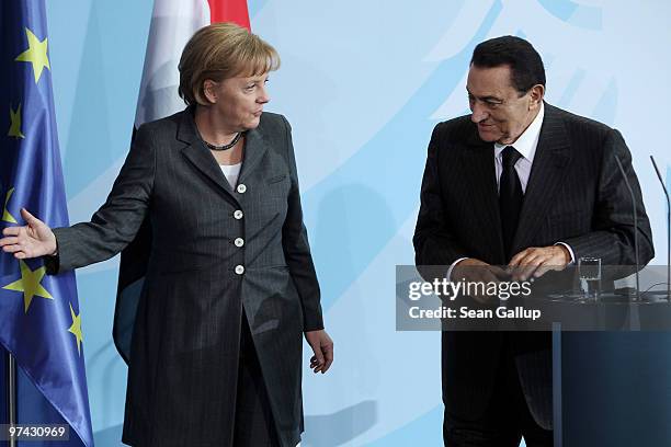 German Chancellor Angela Merkel and Egyption President Hosni Mubarak depart after speaking to the media following talks at the Chancellery on March...