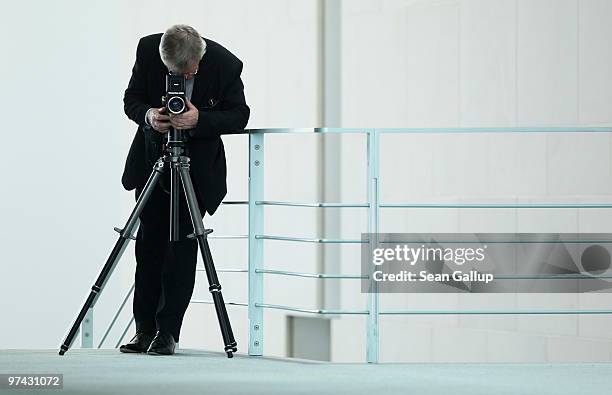 German portrait photographer Konrad R. Mueller waits for the arrival of Chancellor Angela Merkel and Egyption President Hosni Mubarak at a press...