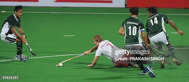 English hockey player Richard Mantell tries to keep the ball from Pakistan hockey players Zeeshan Ashraf and Akhtar Ali during their World Cup 2010...