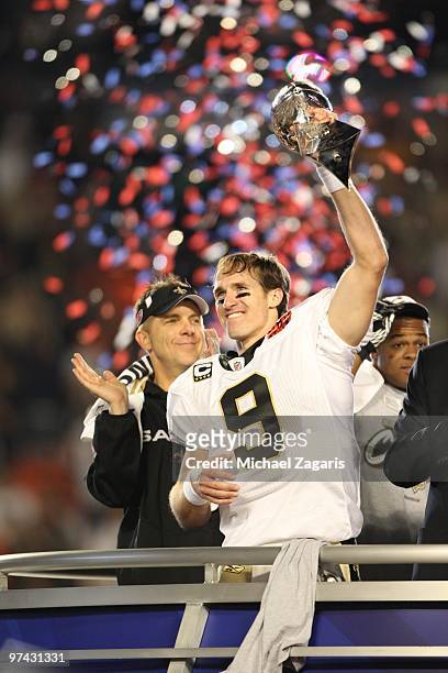 Drew Brees of the New Orleans Saints celebrates with the Super Bowl trophy after Super Bowl XLIV against the Indianapolis Colts at Sun Life Stadium...