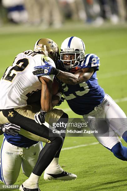 Marques Colston of the New Orleans Saints is tackled after making a reception during Super Bowl XLIV against the Indianapolis Colts at Sun Life...