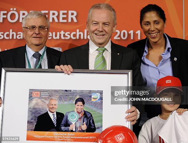 President of the German football association Theo Zwanziger, CEO of German railway giant Deutsche Bahn Ruediger Grube and President of the Organising...