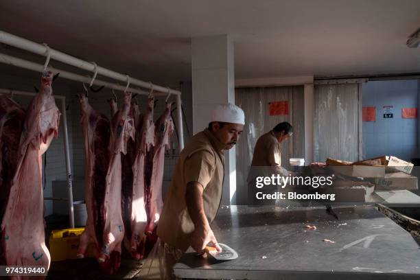 Workers prepare pig carcasses at the Obrador Muoz meat wholesale and distribution center in San Luis Potosi, Mexico, on Friday, June 8, 2018. Mexico...