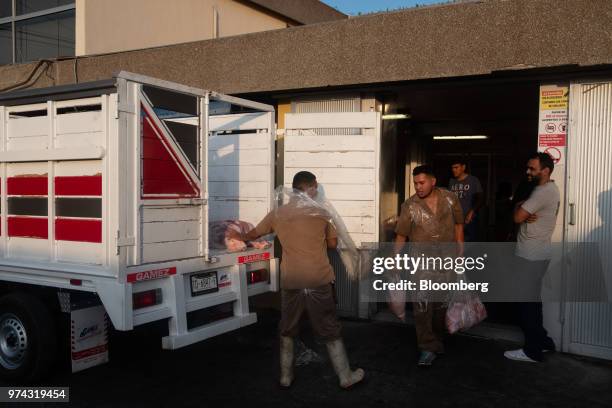 Workers load pork into a truck for delivery at the Obrador Muoz meat wholesale and distribution center in San Luis Potosi, Mexico, on Friday, June 8,...