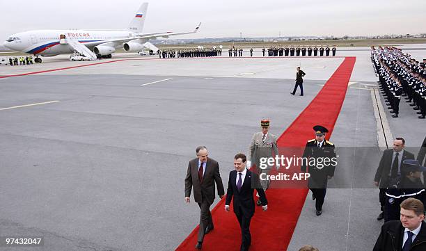 French Culture Minister Frederic Mitterrand and Russian President Dmitry Medvedev review the troops upon Medvedev's arrival at Paris Orly airport, on...