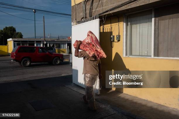 Worker carries pork for delivery at the Obrador Muoz meat wholesale and distribution center in San Luis Potosi, Mexico, on Friday, June 8, 2018....
