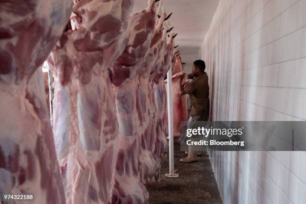 Worker prepares pig carcasses at the Obrador Muoz meat wholesale and distribution center in San Luis Potosi, Mexico, on Friday, June 8, 2018. Mexico...