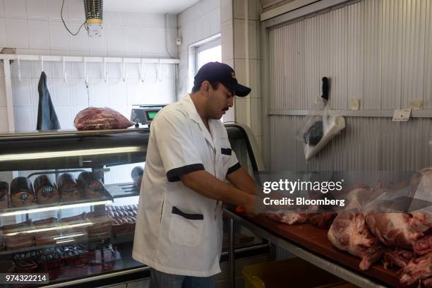 Worker prepares pork for sale at La Nueva Fortuna butcher shop in San Luis Potosi, Mexico, on Friday, June 8, 2018. Mexico will begin to tax a range...