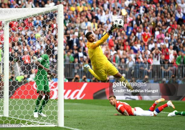 Abdullah Almuaiouf of Saudi Arabia makes a save fromFedor Smolov of Russia during the 2018 FIFA World Cup Russia Group A match between Russia and...