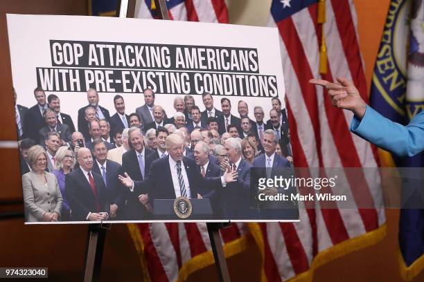 Democratic Minority Leader Nancy Pelosi speaks about health care as she points to a picture of President Trump with House GOP members, during her...