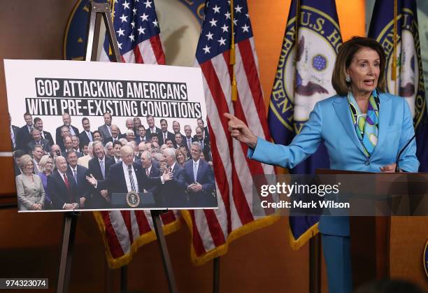 Democratic Minority Leader Nancy Pelosi speaks about health care as she points to a picture of President Trump with House GOP members, during her...