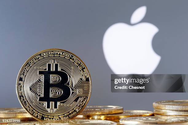 In this photo illustration, a visual representation of the Bitcoin Digital Cryptocurrency sits on display in front of an Apple logo on June 14, 2018...