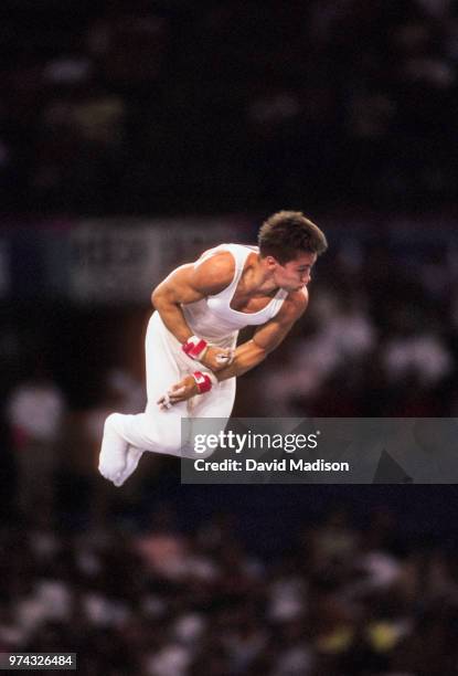 Csaba Fajkusz of Hungary performs on the high bar during the Men's Gymnastics competition of the 1990 Goodwill Games held from July 20 The gymnastics...