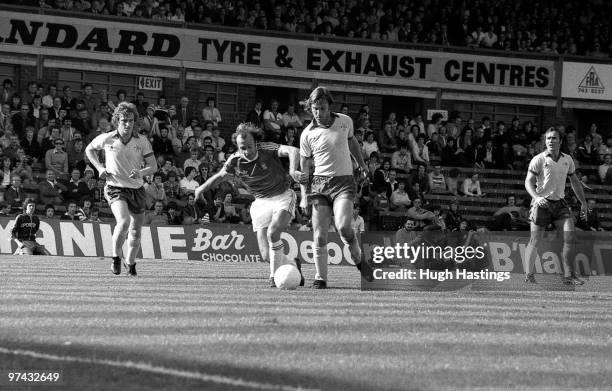 Gary Locke of Chelsea wins possession as he is watched by team-mates Ray Lewington and Ron Harris during the Football League Division One match...