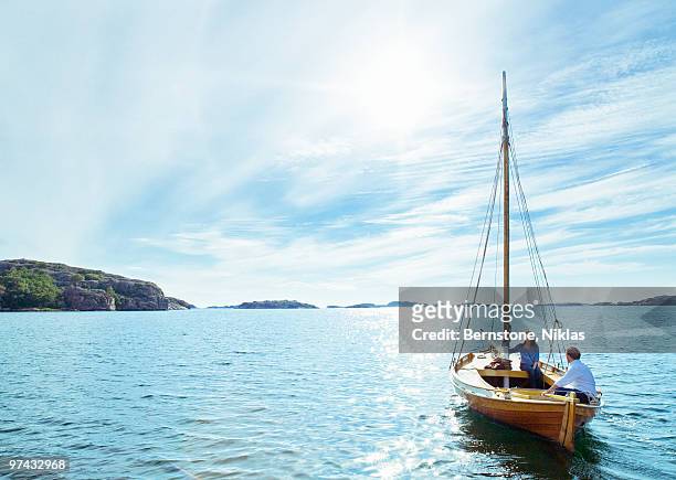 a couple in a sailing-boat, sweden. - vastergotland stock pictures, royalty-free photos & images