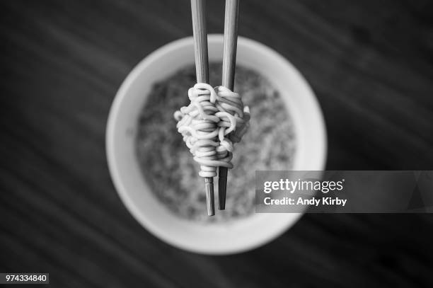 wooden chopsticks holding noodles - holding chopsticks stock pictures, royalty-free photos & images