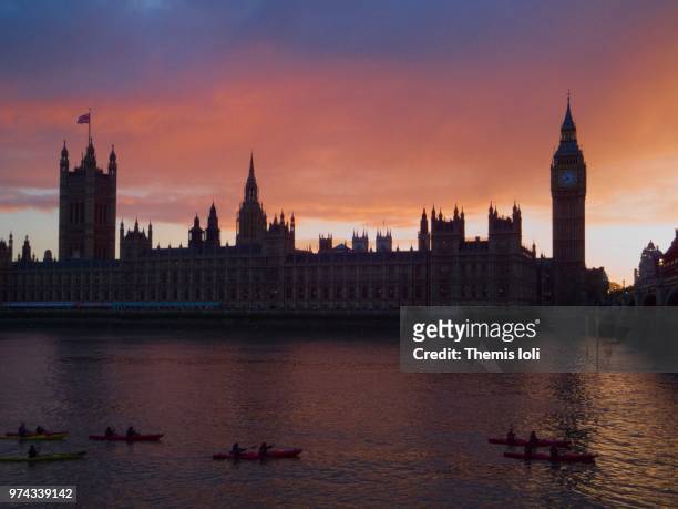 fiery sky behind the parliament - themis stock pictures, royalty-free photos & images