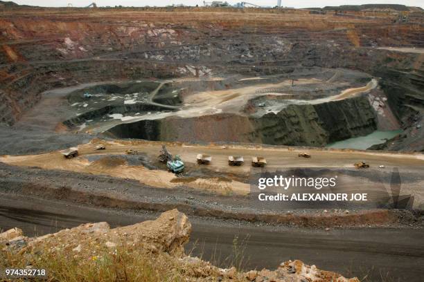 Trucks are loaded with rocks at the world's richest by production value open pit Diamond mine, Jwaneng, 160km south west of Gaborone on March 17,...