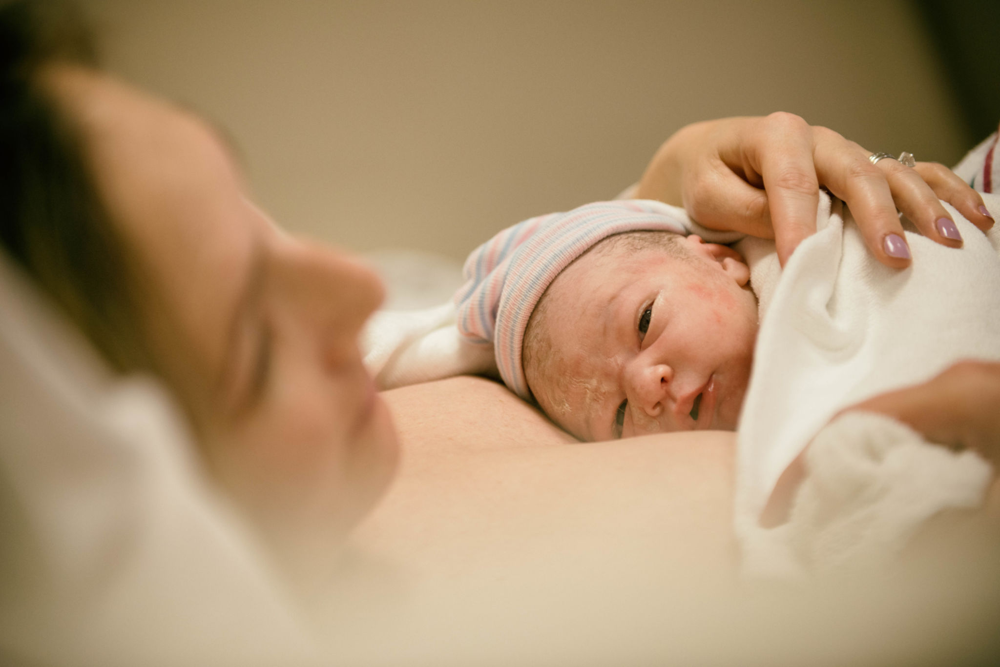 New born opening eyes for the first time after birth New born opening eyes for the first time after birth