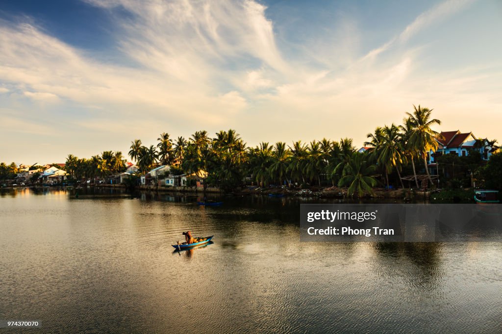 Fisherman is fishing in sunrise at Thu Bon river