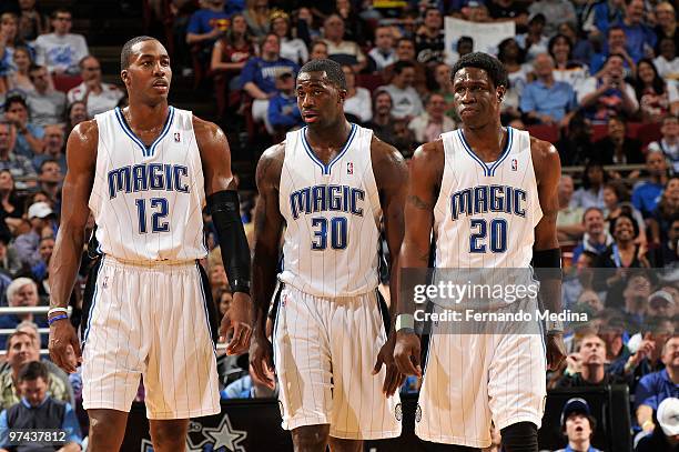 Dwight Howard Brandon Bass and Mickael Pietrus of the Orlando Magic walk down the court during the game against the Cleveland Cavaliers on February...