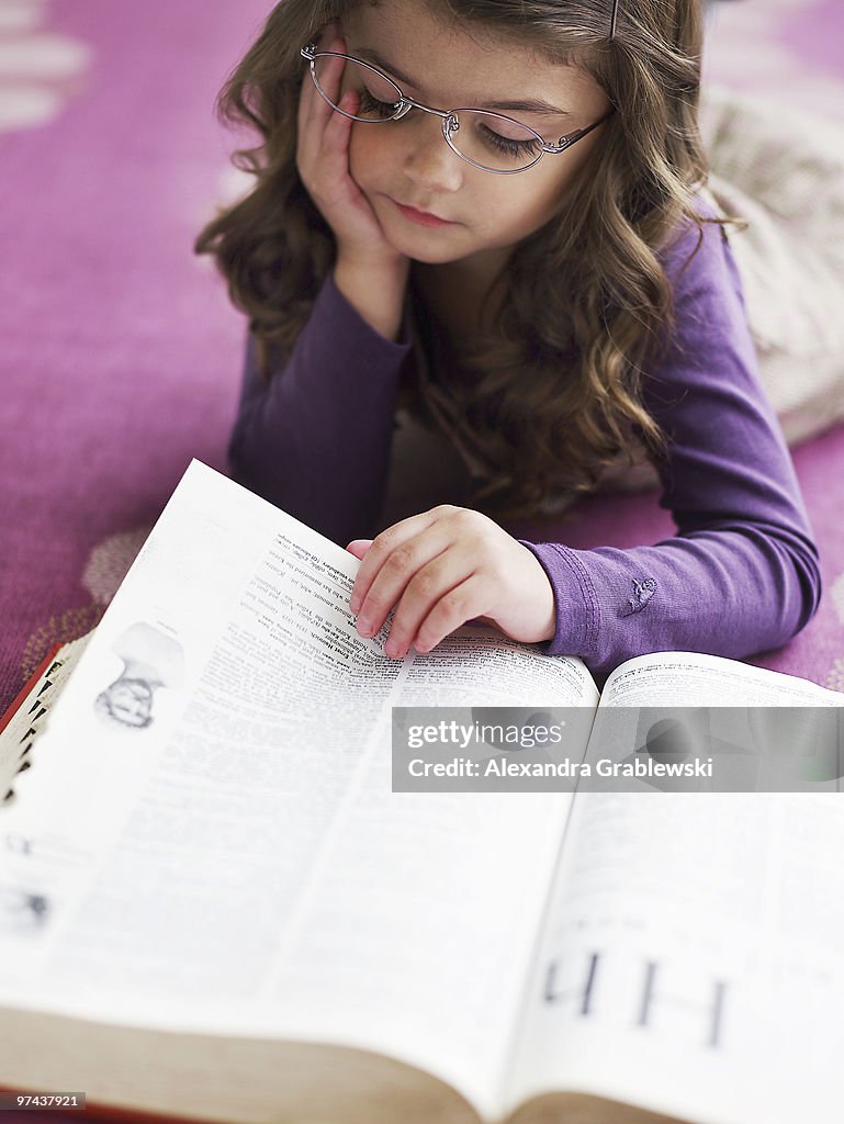Young Girl Reading the Dictionary