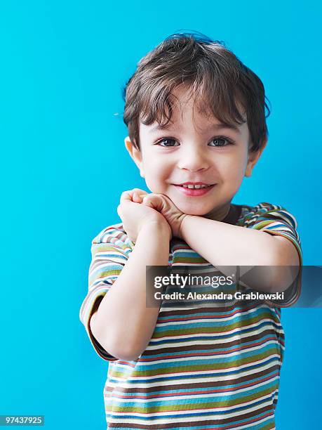 young boy looking pleased - cute baby studioshot stock-fotos und bilder