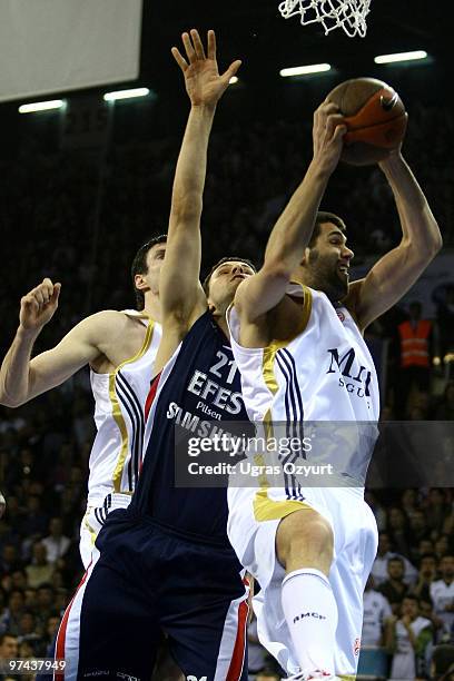 Felipe Reyes, #9 of Real Madrid competes with Bostjan Nachbar, #21 of Efes Pilsen Istanbul during the Euroleague Basketball 2009-2010 Last 16 Game 5...