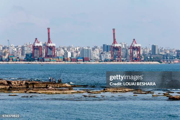 Syrian fishermen wait for the daily catch in Latakia on June 14, 2018.