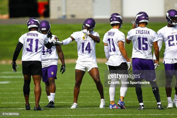 Minnesota Vikings wide receiver Stefon Diggs , center, and Minnesota Vikings running back Mack Brown , left, high five during the Vikings Minicamp on...