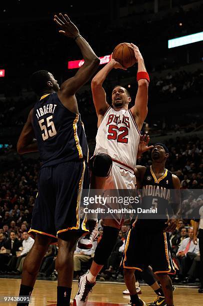 Brad Miller of the Chicago Bulls puts up a shot between Roy Hibbert and T.J. Ford of the Indiana Pacers at the United Center on February 24, 2010 in...