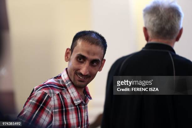 The main defendant Samsoor Lahoo smiles during the trial of human traffickers over the gruesome deaths of 71 migrants who suffocated in a lorry in...