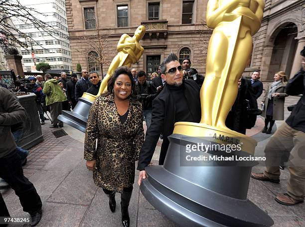 Personality Sherri Shepherd walks with the two eight-foot golden Oscar statues delivered for the official Academy of Motion Picture Arts and Sciences...