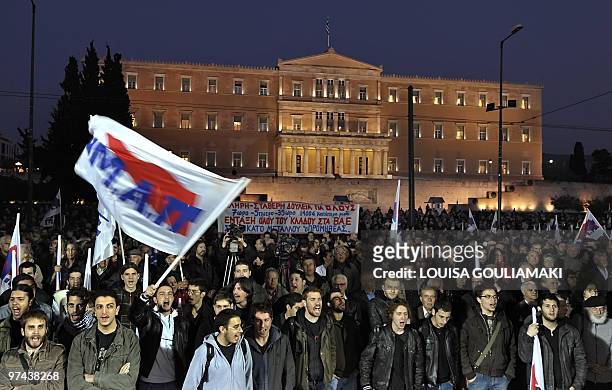 Communist-affiliated demonstrators shout slogans in front of Greek parliament on March 4, 2010 to protest harsh austerity measures announced by the...