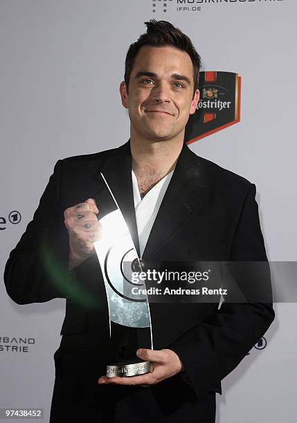 Singer Robbie Williams poses with the Echo award 2010 at the Messe Berlin on March 4, 2010 in Berlin, Germany.