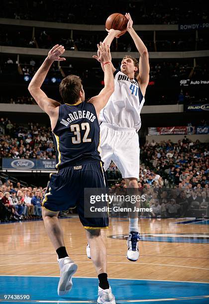 Dirk Nowitzki the Dallas Mavericks takes a jump shot against Josh McRoberts of the Indiana Pacers during the game at the American Airlines Center on...