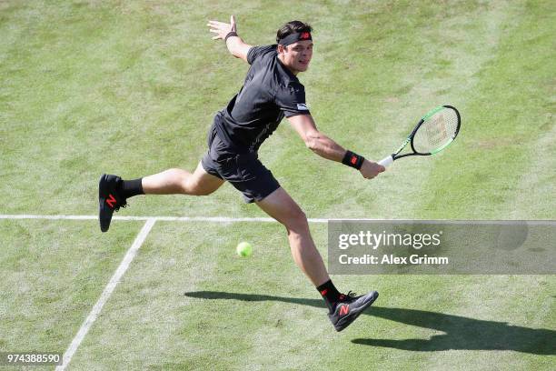 Milos Raonic of Canada plays a backhand to Marton Fucsovics of Hungary during day 4 of the Mercedes Cup at Tennisclub Weissenhof on June 14, 2018 in...