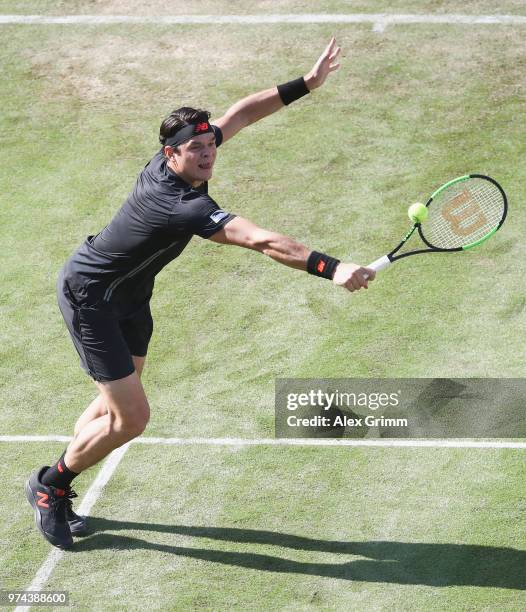 Milos Raonic of Canada plays a backhand to Marton Fucsovics of Hungary during day 4 of the Mercedes Cup at Tennisclub Weissenhof on June 14, 2018 in...