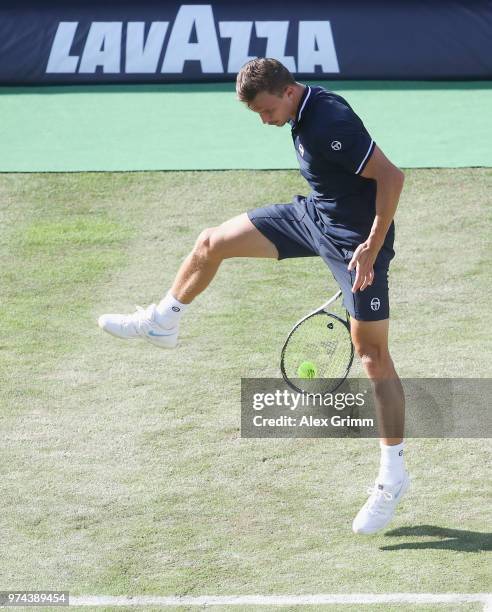Marton Fucsovics of Hungary plays the ball between the legs during his match against Milos Raonic of Canada during day 4 of the Mercedes Cup at...