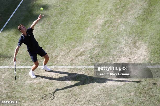 Marton Fucsovics of Hungary serves the ball to Milos Raonic of Canada during day 4 of the Mercedes Cup at Tennisclub Weissenhof on June 14, 2018 in...