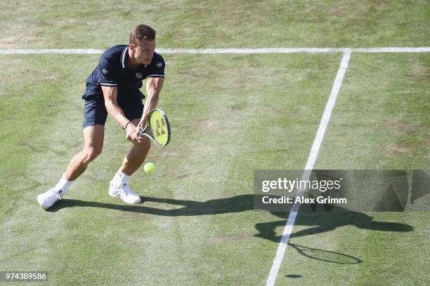 Marton Fucsovics of Hungary plays a backhand to Milos Raonic of Canada during day 4 of the Mercedes Cup at Tennisclub Weissenhof on June 14, 2018 in...