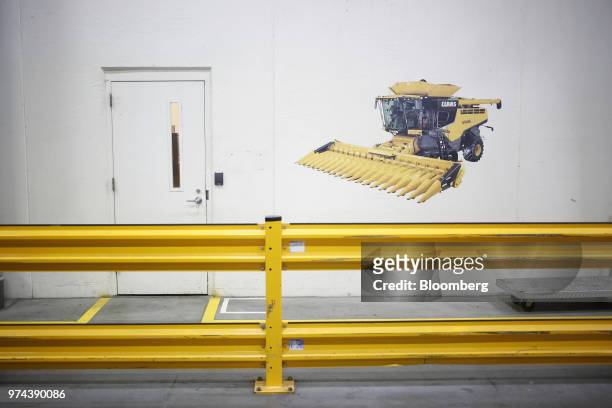 An image of a combine harvester is displayed on a wall at the CLAAS of America Inc. Production facility in Omaha, Nebraska, U.S., on Wednesday, June...