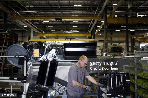 Worker assembles a combine harvester at the CLAAS of America Inc. Production facility in Omaha, Nebraska, U.S., on Wednesday, June 6, 2018. The...