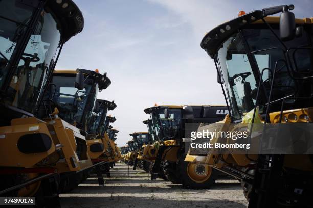Combine harvesters sit parked before shipment at the CLAAS of America Inc. Production facility in Omaha, Nebraska, U.S., on Wednesday, June 6, 2018....