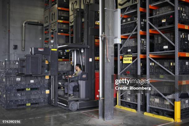 Worker operates a forklift to retrieve parts used in the assembly of combine harvesters at the CLAAS of America Inc. Production facility in Omaha,...