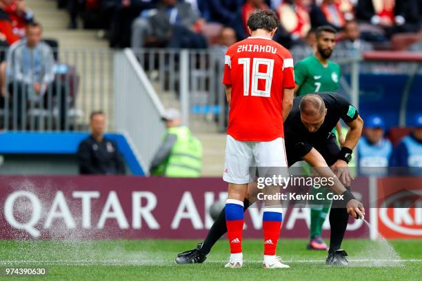 Referee Nestor Pitana uses vanishing spray to mark a the line for a free kick infront of Yury Zhirkov of Russia during the 2018 FIFA World Cup Russia...